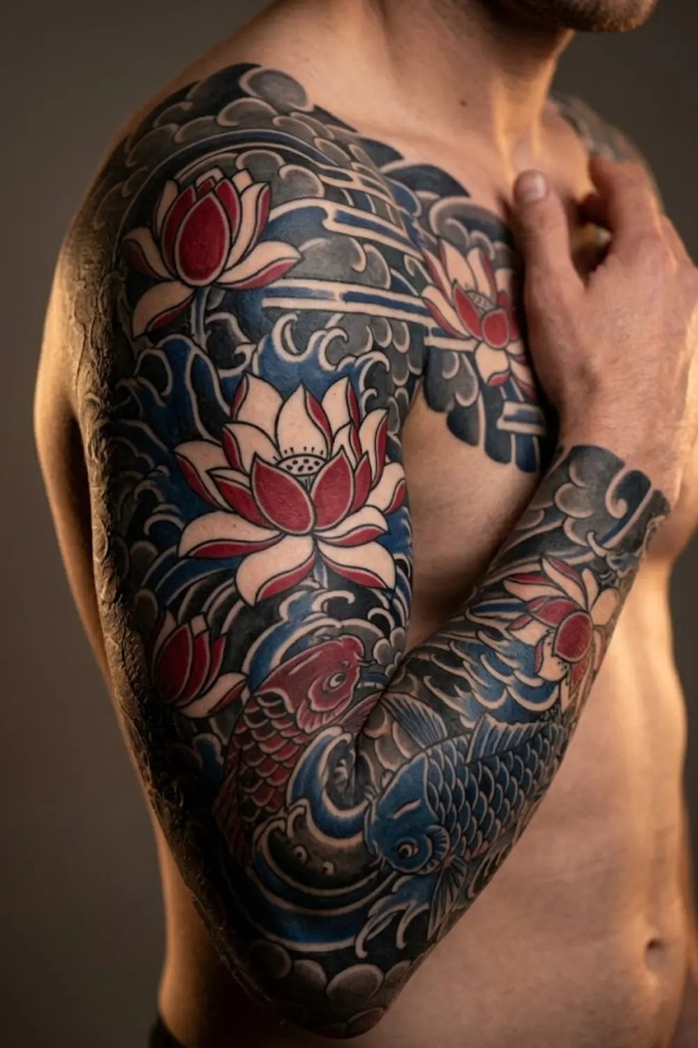 Traditional Japanese irezumi lotus flower tattoo full sleeve with koi fish and water waves